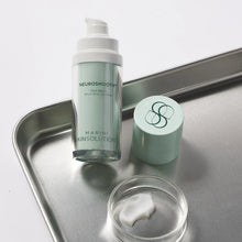 Load image into Gallery viewer, NeurosMOOTH skincare serum bottle on a metal tray with visible branding.