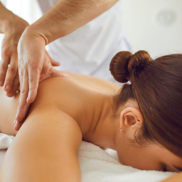 Image of client receiving deep tissue massage on upper back