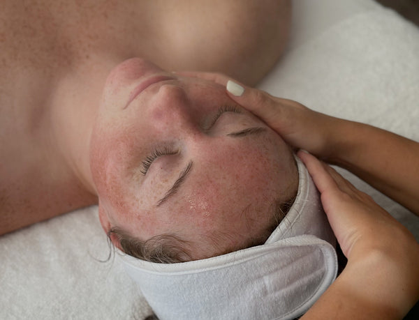 Guest receiving a lymphatic facial massage at Young & Bloom Skin spa in Saratoga Springs, NY