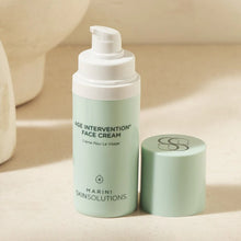 Load image into Gallery viewer, Age intervention face cream bottle with pump on a beige background

