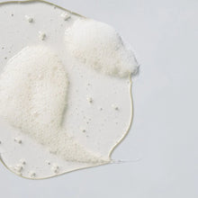 Load image into Gallery viewer, White slushy substance with small white beads on a light gray background

