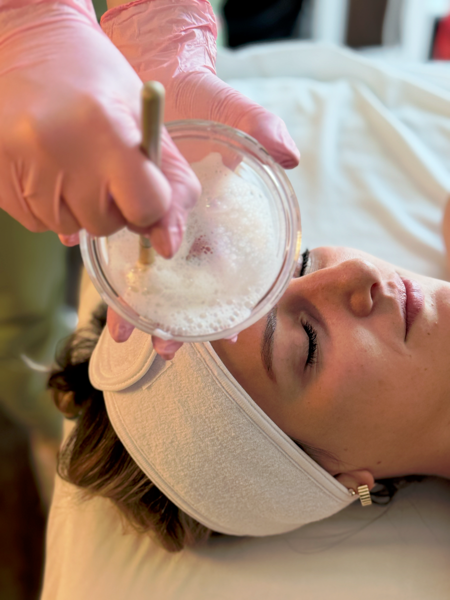 Esthetician prepping a cooling mask at Young & Bloom Skin prior to refreshing HydraFacial