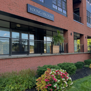 Young and bloom front facade on brick building facing Excelsior Ave