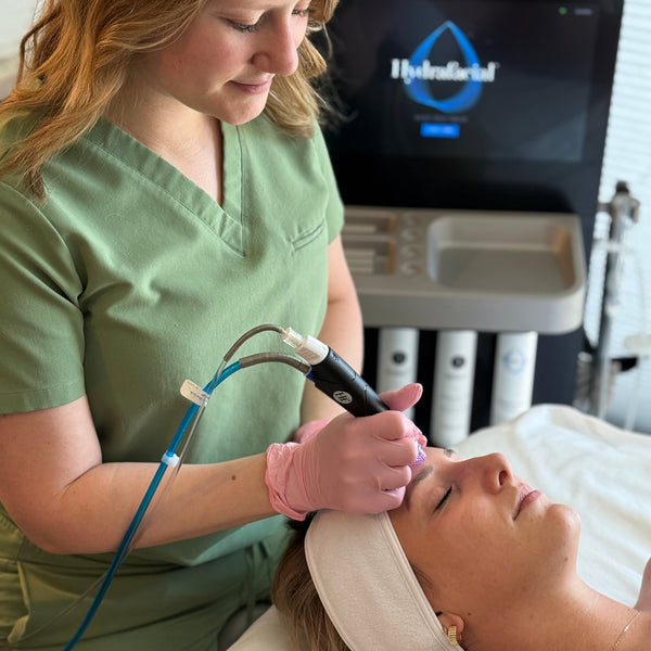 Client receiving a HydraFacial treatment at Young & Bloom Skin in Saratoga Springs for deep cleansing and skin rejuvenation.